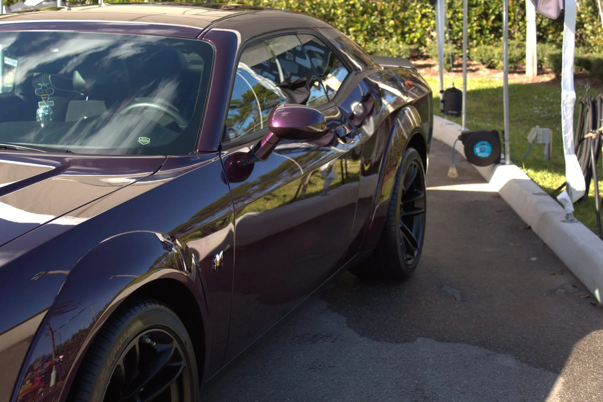 A deep-maroon sports coupe cleaned and polished